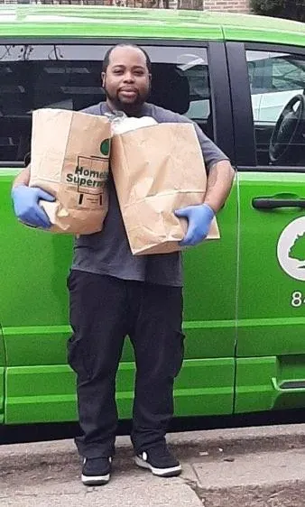 HPH Transport driver delivering groceries to a patient